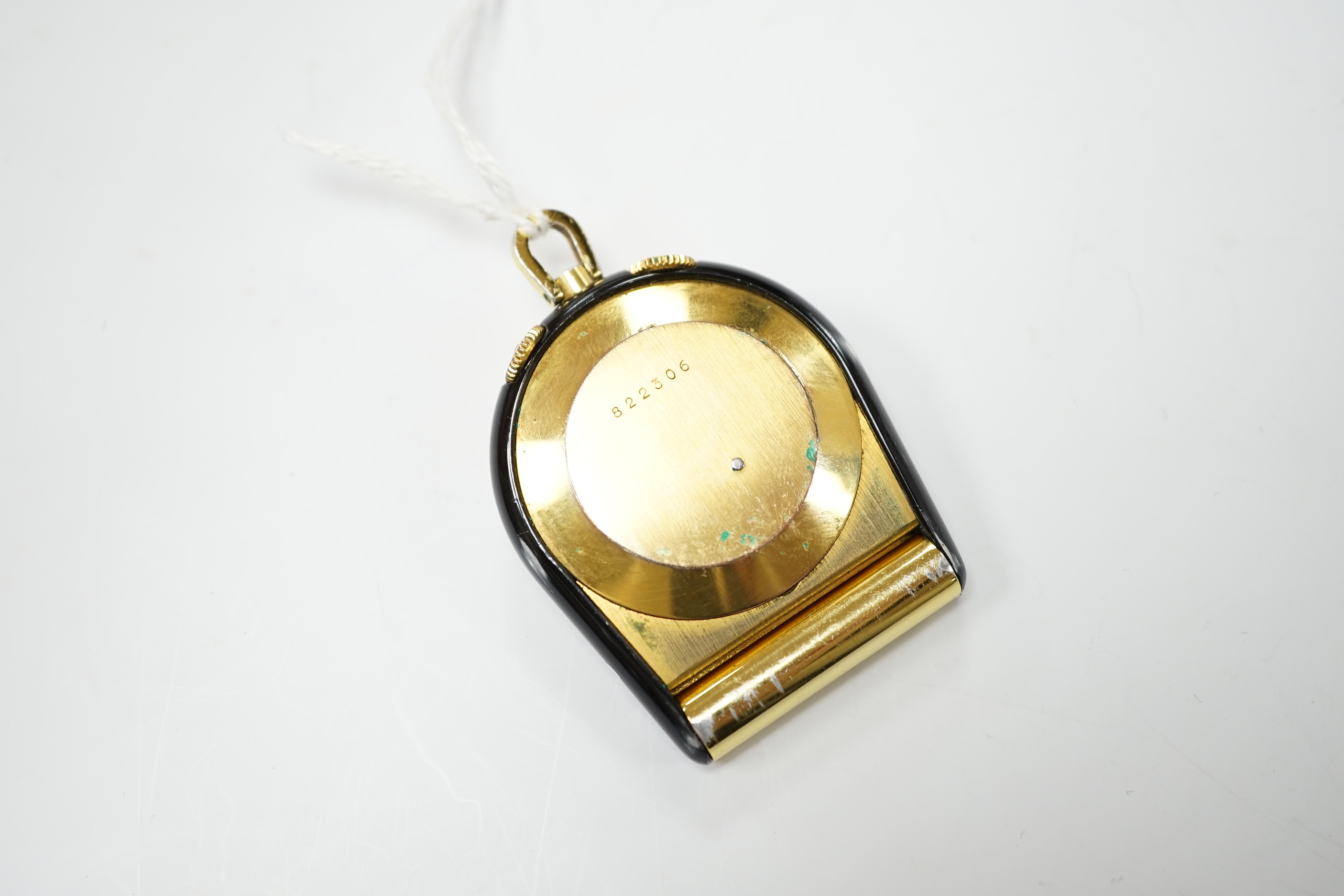 A gilt metal and black enamel Jaeger LeCoultre horseshoe shaped travelling timepiece, 45mm.